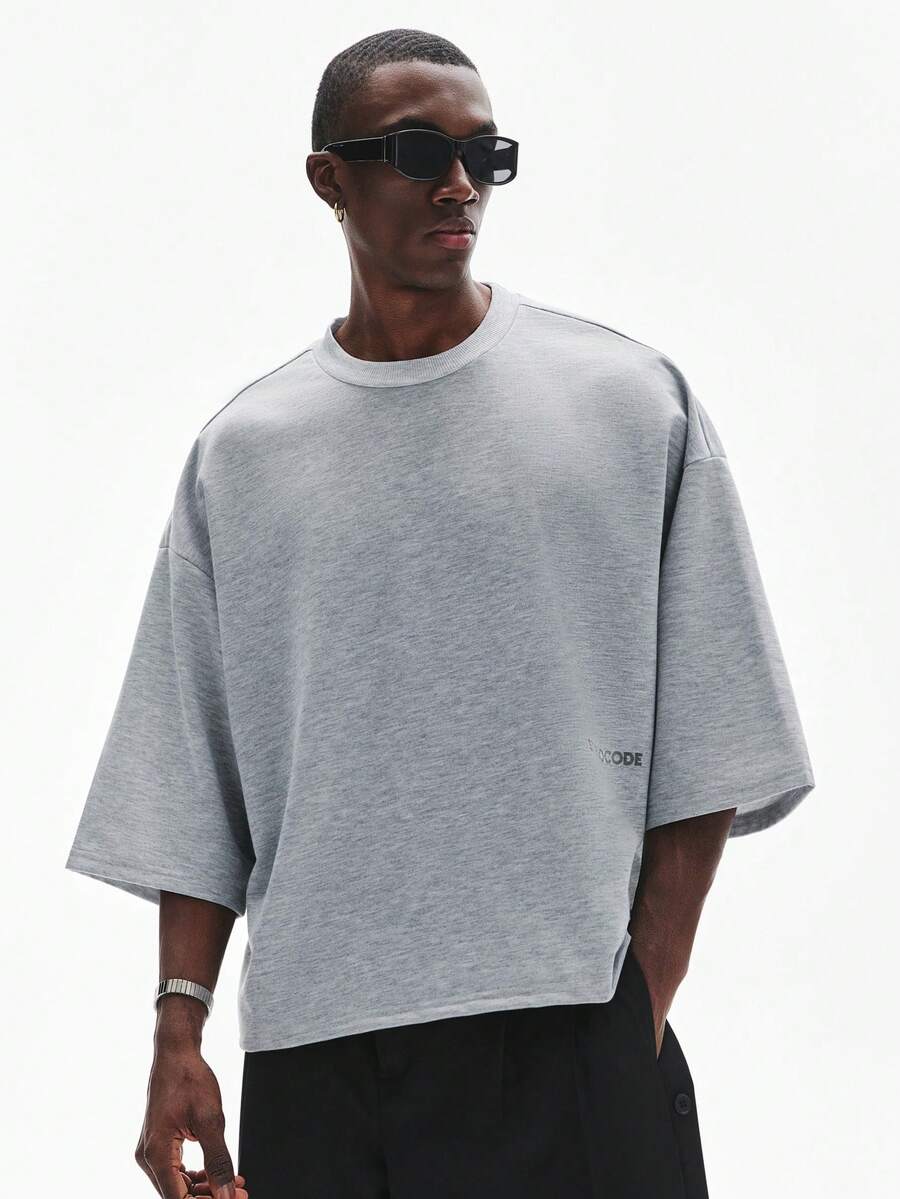 Camiseta suelta de hombro caído con estampado de letras casual para hombre
