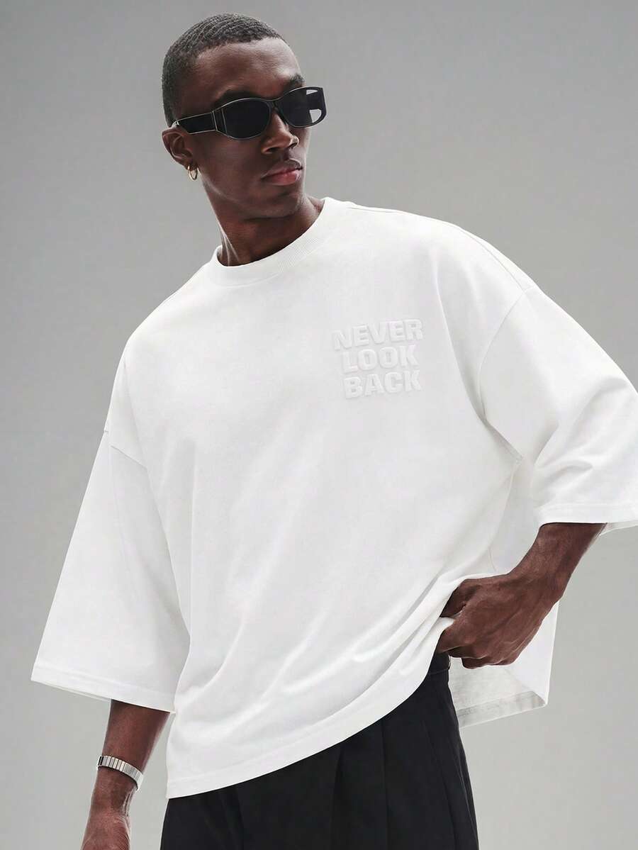 Camiseta suelta de hombro caído con estampado de letras casual para hombre