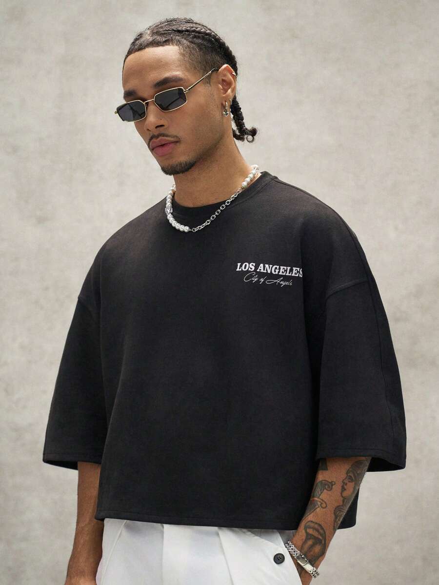 Camiseta suelta de hombro caído con estampado de letras casual para hombre