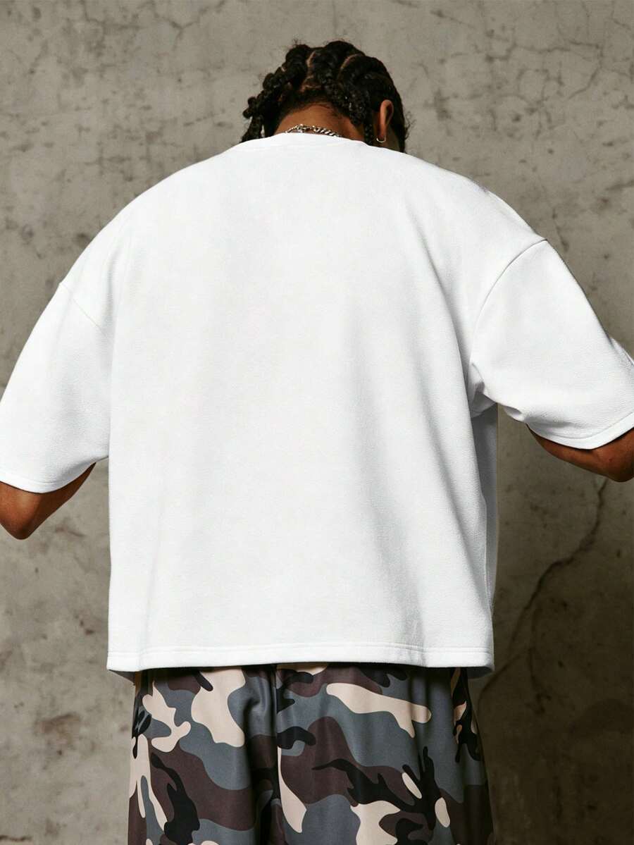 Camiseta suelta de hombro caído con estampado de letras casual para hombre