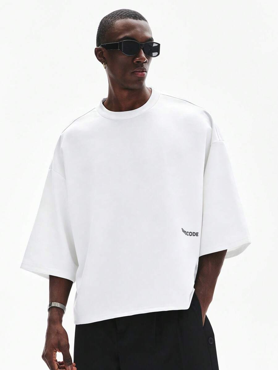 Camiseta suelta de hombro caído con estampado de letras casual para hombre