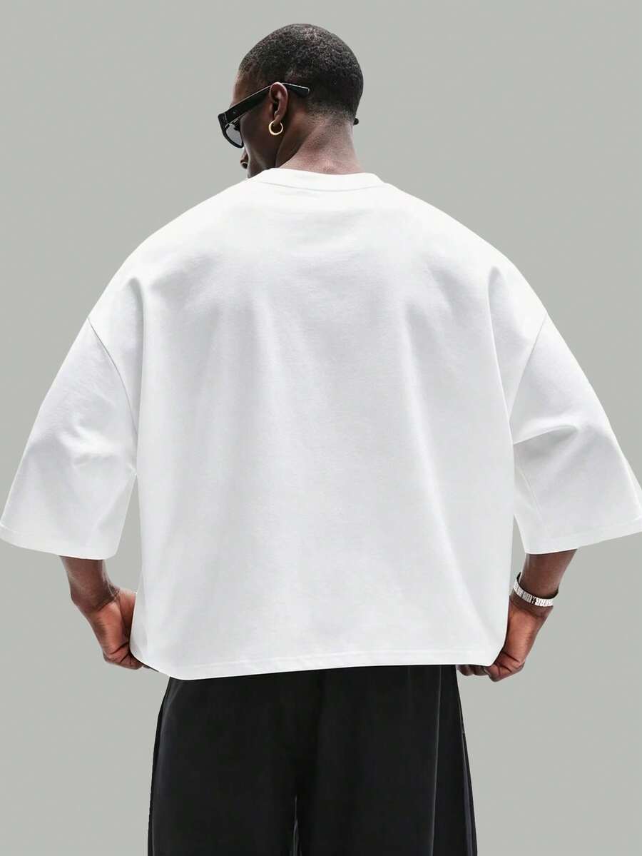 Camiseta suelta de hombro caído con estampado de letras casual para hombre