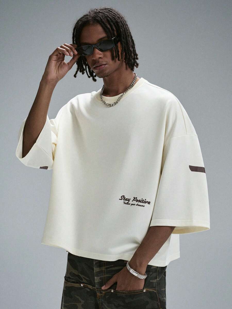 Camiseta suelta de hombro caído con estampado de letras casual para hombre